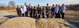 UNE leadership dig into the earth at the groundbreaking ceremony for the Harold and Bibby Center for Health Sciences on Tuesday, Nov. 29, 2022